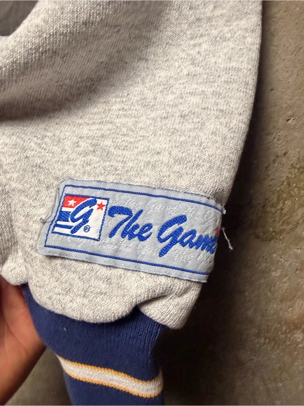 The Game Men’s Gray Crewneck Sweatshirt with Navy Trim and Green Logo